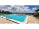 Gorgeous community pool with lounge chairs and beautiful lake views, perfect for relaxation at 658 Olympic Dr, Ocoee, FL 34761