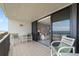 Relax on the balcony with a peek into the living room with sliding glass door at 6727 Turtlemound Rd # 417, New Smyrna Beach, FL 32169