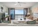 Bright living room with a ceiling fan and sliding glass doors to the ocean-view balcony at 6727 Turtlemound Rd # 417, New Smyrna Beach, FL 32169