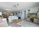 Comfortable living room with modern furniture, light blue walls and access to the dining area at 6727 Turtlemound Rd # 417, New Smyrna Beach, FL 32169