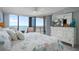 Serene main bedroom featuring a television, dresser, and ocean views from the balcony at 6727 Turtlemound Rd # 417, New Smyrna Beach, FL 32169
