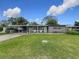 Single-story home with a carport and expansive green lawn, showcasing a welcoming curb appeal at 724 Alfred Dr, Orlando, FL 32810