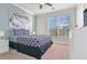 Bedroom showcasing a large window, patterned bedding, and a ceiling fan at 8000 Tuscany Way # 4405, Davenport, FL 33896