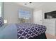 Comfortable bedroom featuring a large window and patterned bedding at 8000 Tuscany Way # 4405, Davenport, FL 33896