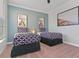 Bedroom featuring two twin beds with patterned bedding and decorative wall art at 8000 Tuscany Way # 4405, Davenport, FL 33896