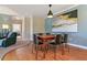 Well-lit dining room with wood floors, large painting, and contemporary light fixture at 8000 Tuscany Way # 4405, Davenport, FL 33896