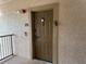 Condo front door with secure entry features and a lockbox for easy access at 8000 Tuscany Way # 4405, Davenport, FL 33896