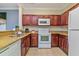 Spacious kitchen with stainless steel sink, tile backsplash, and white appliances at 8000 Tuscany Way # 4405, Davenport, FL 33896