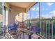 Relaxing screened condo patio with seating, table and pretty outdoor view at 8000 Tuscany Way # 4405, Davenport, FL 33896