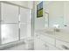 Clean bathroom featuring tiled shower, with a bright vanity and fixtures at 8149 Via Vittoria Way, Orlando, FL 32819