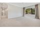 Spacious bedroom with light-colored carpet, large windows, and modern curtains at 8149 Via Vittoria Way, Orlando, FL 32819