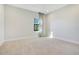 This bedroom is spacious with neutral walls and a large window for natural light at 8149 Via Vittoria Way, Orlando, FL 32819