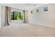 Spacious bedroom with light-colored carpet, large windows, custom wall paper, and modern curtains at 8149 Via Vittoria Way, Orlando, FL 32819