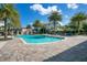 Community pool with lounge chairs and umbrellas surrounded by manicured landscaping at 8149 Via Vittoria Way, Orlando, FL 32819