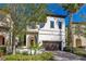 Charming two-story home featuring a terracotta tile roof and a manicured front yard at 8149 Via Vittoria Way, Orlando, FL 32819