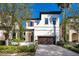 Charming two-story home featuring a terracotta tile roof and a manicured front yard at 8149 Via Vittoria Way, Orlando, FL 32819