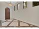Elegant foyer with tiled floors, arched wooden door, and natural light from multiple windows at 8149 Via Vittoria Way, Orlando, FL 32819