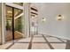 Spacious living room with wood floors, high ceilings, beams, and glass sliding doors leading to outdoor patio at 8149 Via Vittoria Way, Orlando, FL 32819