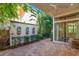 An outdoor brick patio with potted plants and outdoor wall water fountains at 8149 Via Vittoria Way, Orlando, FL 32819