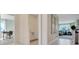 Bright hallway showcases access to a laundry room, home office, and living room at 903 Princess Sabal Pt, Haines City, FL 33844