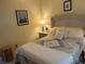 Inviting bedroom with a comfortable bed, bedside table, and tasteful decor for a relaxing atmosphere at 103 Dreama Dr, Davenport, FL 33897
