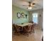 Inviting dining area with a ceiling fan, seating for four, and tasteful decor at 103 Dreama Dr, Davenport, FL 33897