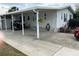 Spacious carport and driveway of a well-maintained single story home in a Florida community at 103 Dreama Dr, Davenport, FL 33897