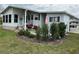 Inviting home entrance with lovely landscaping, seating area and tasteful decor at 103 Dreama Dr, Davenport, FL 33897