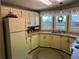 Cozy kitchen featuring white cabinets, a double basin sink, and bright windows at 103 Dreama Dr, Davenport, FL 33897