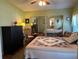 Bright bedroom featuring a large mirrored closet, a queen-size bed, and soft lighting at 103 Dreama Dr, Davenport, FL 33897
