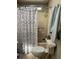 Shower with patterned curtain, towels, and toiletry storage at 103 Dreama Dr, Davenport, FL 33897