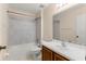 Bathroom with white tiled shower-tub and vanity with white sink and light wood cabinets at 113 Glasgow Ct, Davenport, FL 33897