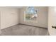 Neutral bedroom featuring carpeted floors and a bright window for plenty of natural light at 113 Glasgow Ct, Davenport, FL 33897