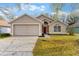 Charming single Gathering home featuring a two-car garage and a well maintained lawn at 113 Glasgow Ct, Davenport, FL 33897