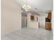 Open-concept kitchen and dining area with tiled floors, a chandelier, and ample natural light at 113 Glasgow Ct, Davenport, FL 33897
