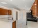 Traditional kitchen featuring wood cabinets, white countertops and tile flooring at 113 Glasgow Ct, Davenport, FL 33897