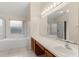 Main bathroom featuring a soaking tub, glass enclosed shower, and a vanity at 113 Glasgow Ct, Davenport, FL 33897
