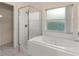 Main bathroom featuring a walk-in shower and a separate soaking tub at 113 Glasgow Ct, Davenport, FL 33897