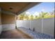 Covered back patio with white stone landscaping and a white fence at 1132 Hardy Ave Ave, Orlando, FL 32803