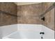 Close up of the tiled shower-tub with decorative accent tiles and black fixtures at 1132 Hardy Ave Ave, Orlando, FL 32803