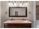 Close-up of bathroom vanity with double sinks, granite countertops, and bronze fixtures at 1132 Hardy Ave Ave, Orlando, FL 32803