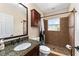 Well-lit bathroom featuring a granite vanity, shower, and dark wood accents at 1132 Hardy Ave Ave, Orlando, FL 32803