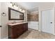 Spacious bathroom featuring a double sink vanity, large mirror, and combination tub and shower at 1132 Hardy Ave Ave, Orlando, FL 32803