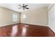 Bright bedroom featuring hardwood floors, a ceiling fan, and two windows that provide natural light at 1132 Hardy Ave Ave, Orlando, FL 32803