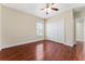 Bedroom showcasing hardwood floors, a ceiling fan, a window, and a large closet at 1132 Hardy Ave Ave, Orlando, FL 32803