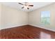 Bedroom featuring hardwood floors, a ceiling fan, and a window offering natural light at 1132 Hardy Ave Ave, Orlando, FL 32803