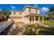 Charming two-story home with covered front porch, tan exterior, and attached garage at 1132 Hardy Ave Ave, Orlando, FL 32803
