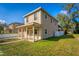 Side view of a two-story home with a covered porch and a well-manicured lawn at 1132 Hardy Ave Ave, Orlando, FL 32803