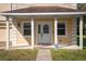 Inviting front porch with white columns, a white front door, and manicured lawn at 1132 Hardy Ave Ave, Orlando, FL 32803