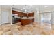 Open concept kitchen features wood cabinets, stainless steel appliances, and travertine flooring at 1132 Hardy Ave Ave, Orlando, FL 32803